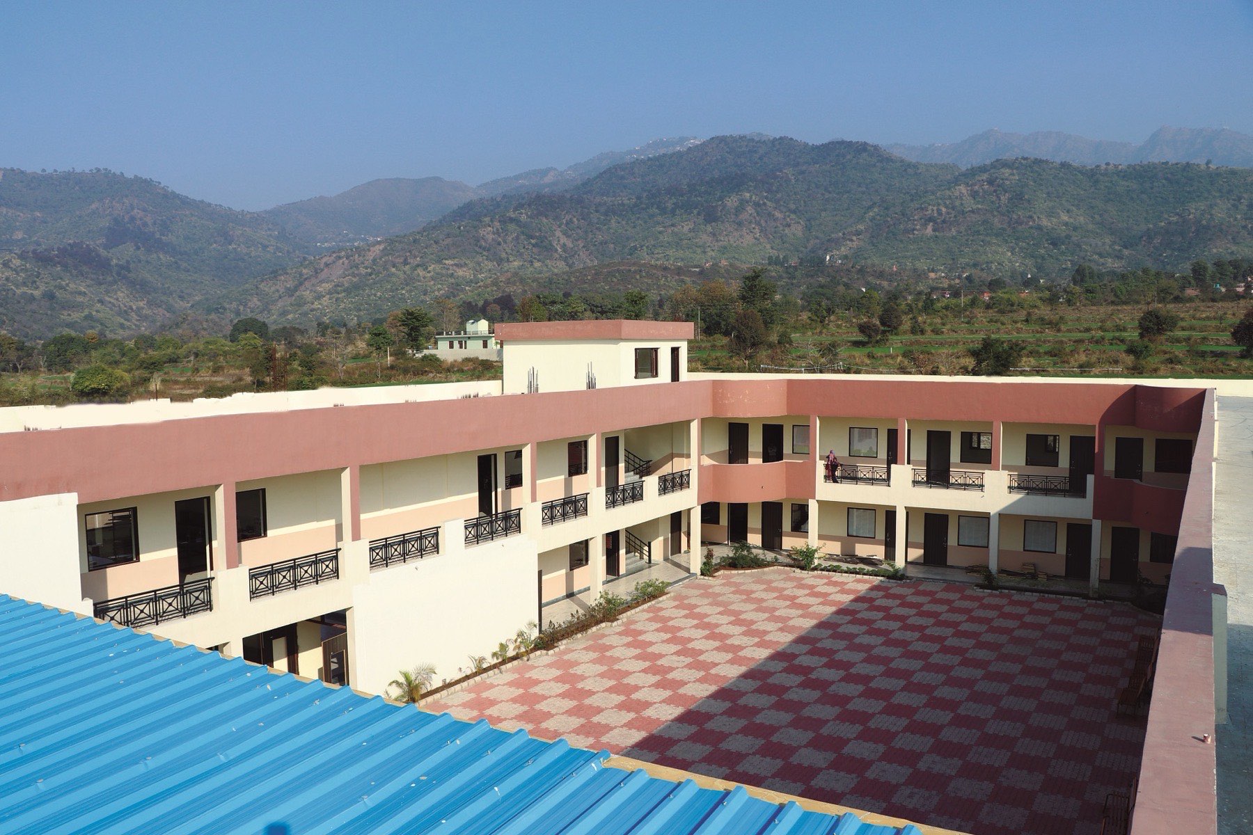 School buildings with the Shivalik hills rising behind the campus