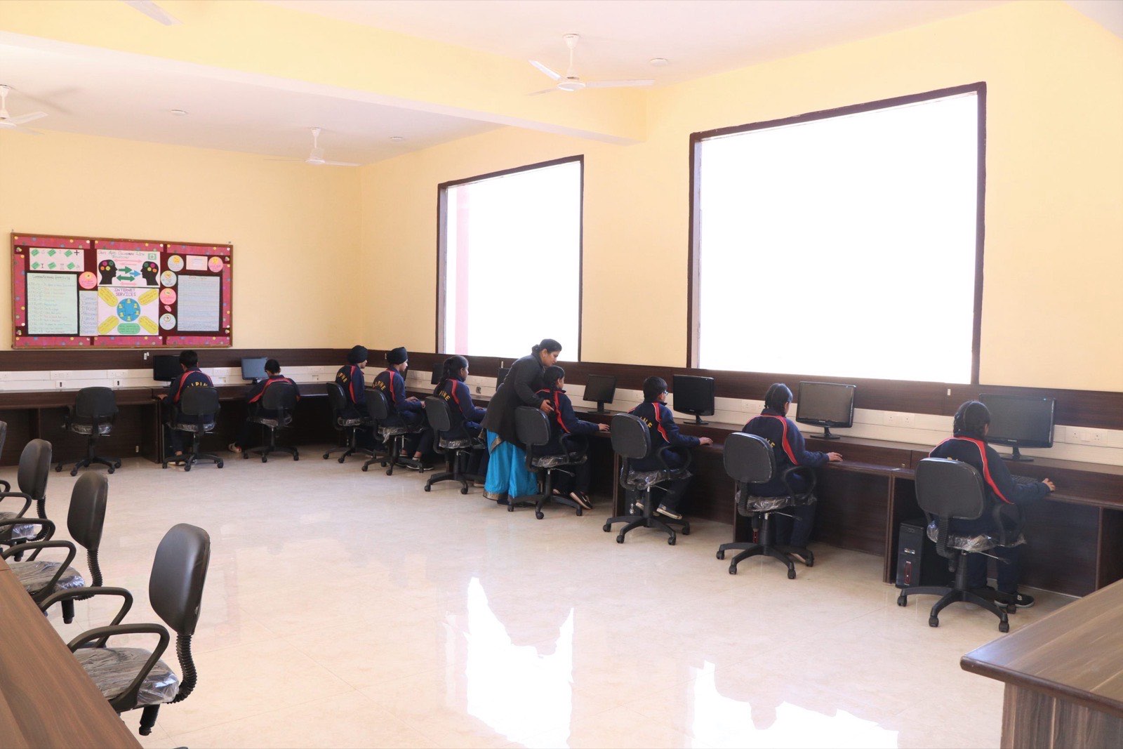 Wide view of the school computer laboratory in use