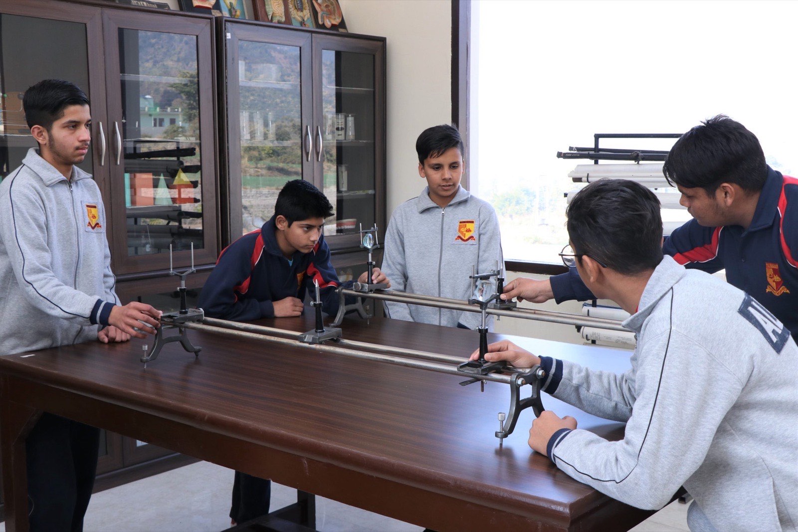 Senior students conducting a physics experiment in the science laboratory